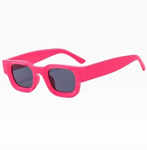 Detail view of bold pink square frame sunglasses with dark grey protective lenses