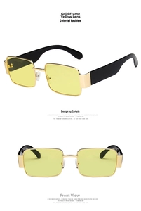 Detail view of square gold metal sunglasses with yellow lenses and black temples