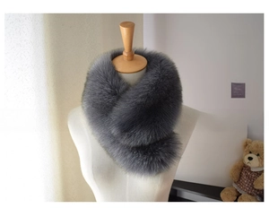 Close-up of thick dark grey faux fox fur scarf showing fluffy texture and plush volume
