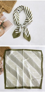 Detail of olive green silk scarf with geometric leaf patterns and striped texture