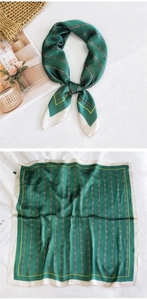 Detail of green silk square scarf featuring elegant brown chain link pattern and cream border