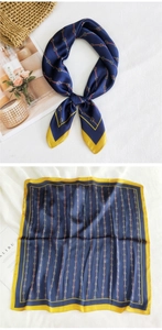 Detailed pattern of a navy silk scarf with horse-bit motifs and red-green stripes