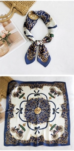 Detailed close-up of navy blue and gold silk scarf with baroque equestrian carriage print