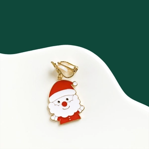 Detail of Christmas Santa Claus clip-on earring with red and white enamel on green base