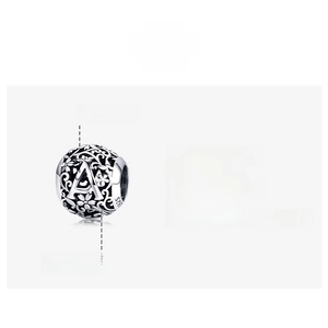 Macro shot of S925 silver letter A bead with hollow floral pattern and vintage oxidation