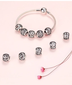 Detailed macro of S925 sterling silver charm bracelet with letter beads and Forever clasp