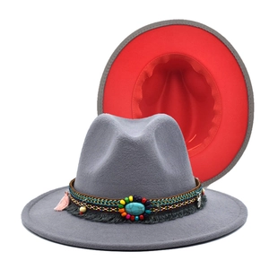 Detail of wool fedora with ethnic woven band, turquoise stone, and pink tassel trim