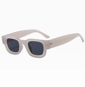Detail view of cream matte square sunglasses frame with high-quality dark grey lenses
