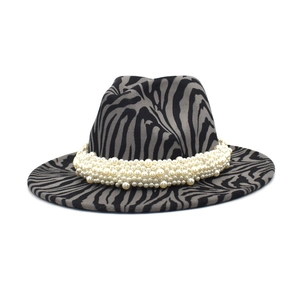 Close-up of zebra pattern wool jazz hat with elegant pearl band and wide brim detail