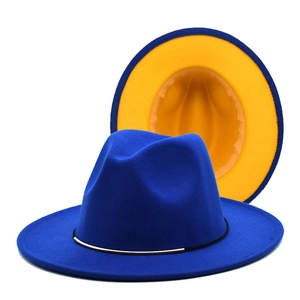 Detail of royal blue wool fedora featuring contrasting yellow lining and gold metal trim
