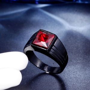Macro shot of men's square red gemstone ring with black band and side grooves detail
