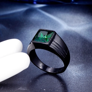 Macro detail of men's square green gemstone ring with black textured steel band
