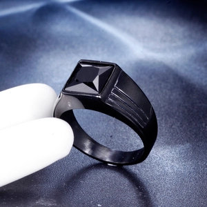 Macro shot of men's square black gemstone ring with a sleek black plated stainless steel band