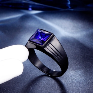Macro side view of men's square-cut blue gemstone ring with black textured steel band