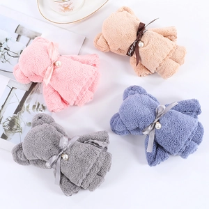 Set of four coral fleece hand towels folded into cute bears with pearls and bows