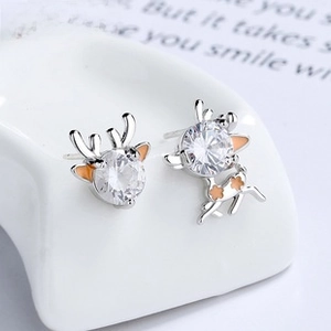 Detailed macro view of asymmetric reindeer stud earrings in 925 silver and zircon