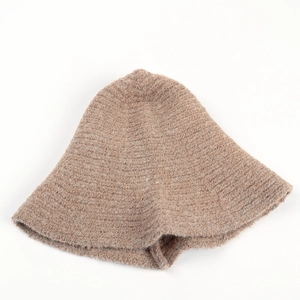 Detailed texture of beige knit bucket hat with soft plush fleece fabric for winter