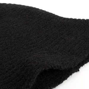 Close-up of black bouclé knit fabric showing textured wool blend detail of bucket hat