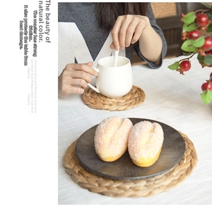 Macro detail of natural water hyacinth woven coaster showing spiral texture and fiber