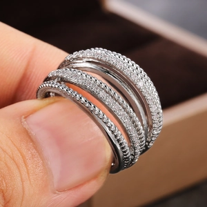 Macro shot of silver multi-layer crossover ring with pave cubic zirconia and rope details