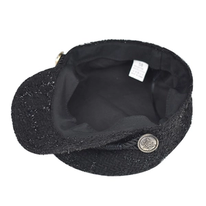 Elegant women's black tweed newsboy cap featuring metallic buttons and rope trim detail