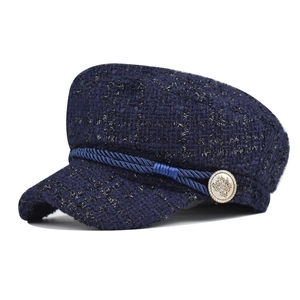 Elegant navy blue tweed baker boy hat with decorative gold crest button for women