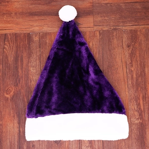 Detailed view of a purple plush Christmas hat with white faux fur trim on wood
