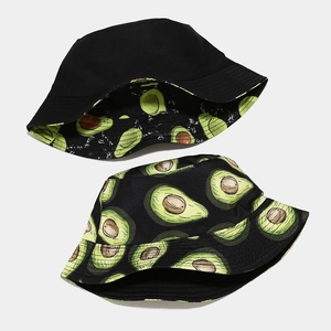 Flat lay detail showing reversible bucket hat with black side and avocado print pattern