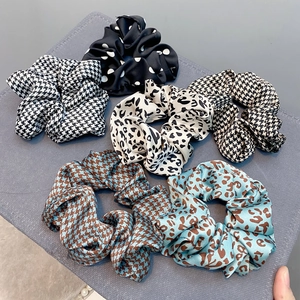 Set of stylish scrunchies featuring houndstooth, leopard print, and polka dot patterns