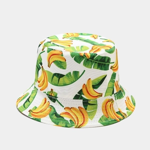 Detail of banana print on white canvas bucket hat featuring vibrant tropical fruit pattern