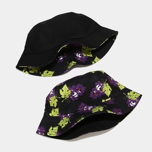 Detail of reversible black bucket hat with cartoon purple grape pattern for sun protection