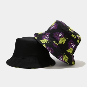Detail of cotton bucket hats showing purple grape print and solid black design textures