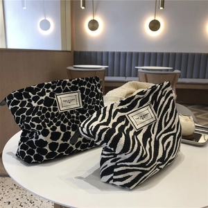 Close-up of leopard and zebra print canvas cosmetic bags with Time to Party fabric label