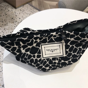 Detail view of canvas makeup bag with black white leopard pattern and text label