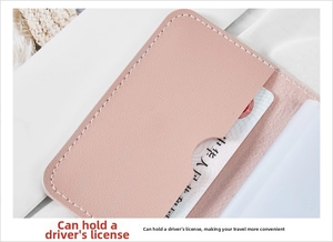 Close-up of pink litchi grain leather card holder with white stitching and notch