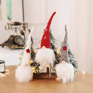 Three Christmas gnomes with long hats and star embroidery in white red and grey colors
