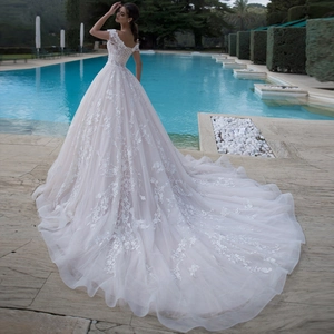 Elegant white ball gown wedding dress with lace floral embroidery and long cathedral train