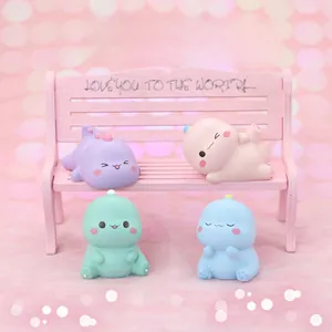 Set of four cute macaron-colored dinosaur figurines sitting on a miniature pink bench
