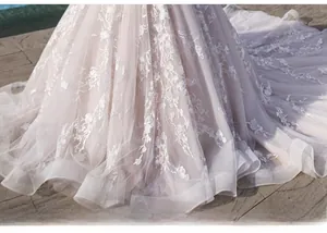 Detail of multi-layer tulle bridal gown featuring floral embroidery and sequins