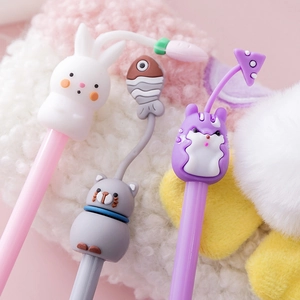 Three cute cartoon gel pens with animal 3D toppers on soft pastel plush background