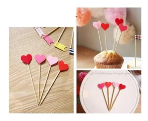 Three-color heart-shaped wooden cake toppers displayed on a dessert plate and cake