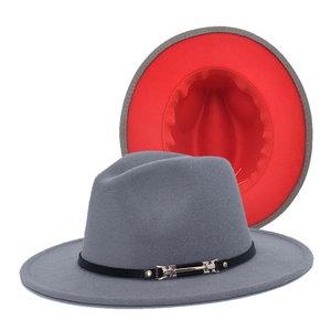 Detail view of a two-tone wool fedora with gold buckle and red inner lining