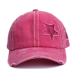 Vintage pink distressed baseball cap with sparkly star patches and frayed edge details