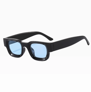 Side view detail of black thick rectangular frame sunglasses with light blue lenses