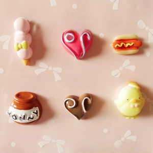 Flat lay of cute resin food charms with precise millimeter size measurements