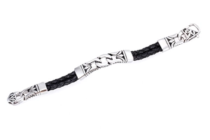 Detailed macro view of punk braided black leather bracelet with vintage steel floral motifs