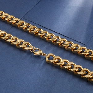 Polished gold cuban link chain necklace with lobster clasp on deep blue background