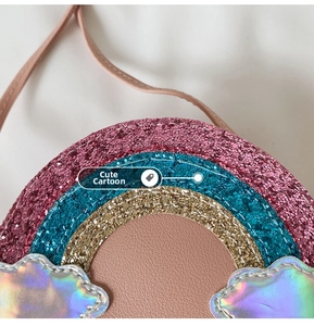 Close-up of glitter rainbow purse with holographic clouds and pink leather shoulder strap