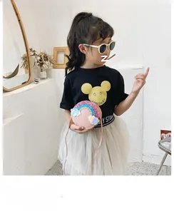 Detailed view of kids pink round crossbody bag with sequin rainbow and laser cloud charms