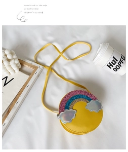 Detailed shot of yellow round girls rainbow bag with sequins and silver cloud charms